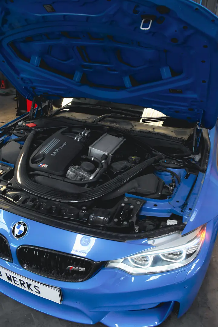 Blue BMW with the bonnet open and a 9 WERKS number plate
