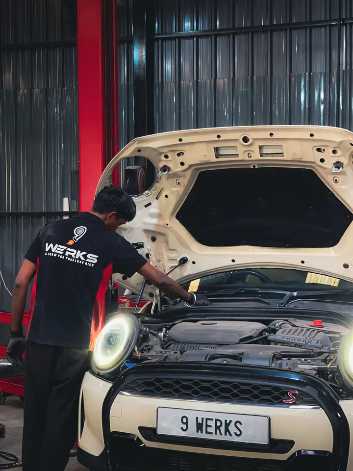 Technician in a 9WERKS shirt working on an engine bay